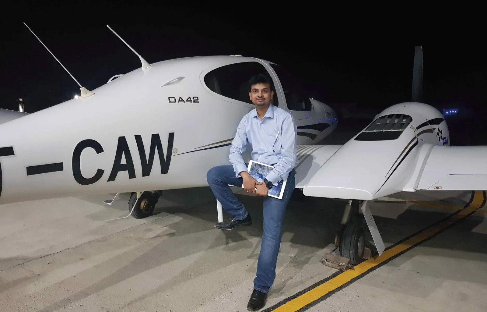 Nikhil Sharma, founder of Vibence, beside a Diamond DA42 aircraft