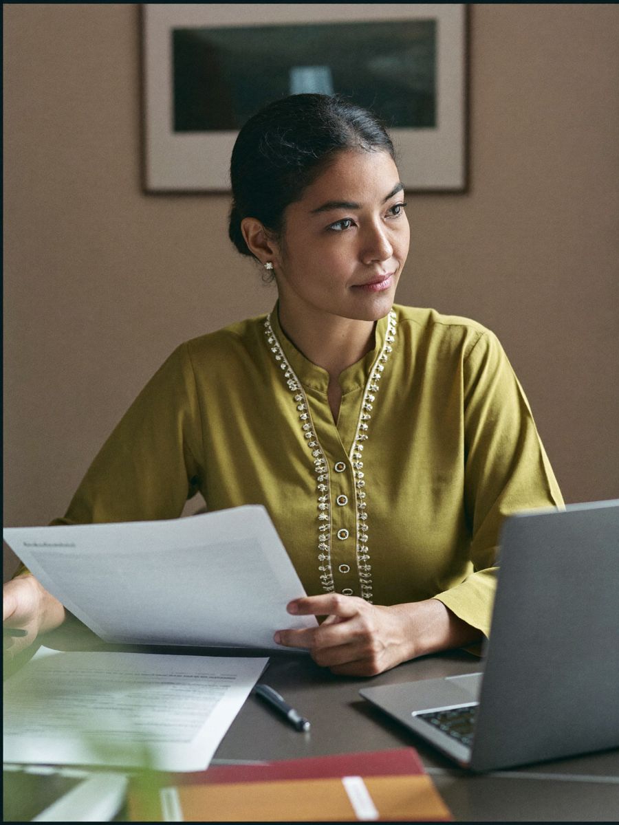 A professional reviewing paperwork at a desk